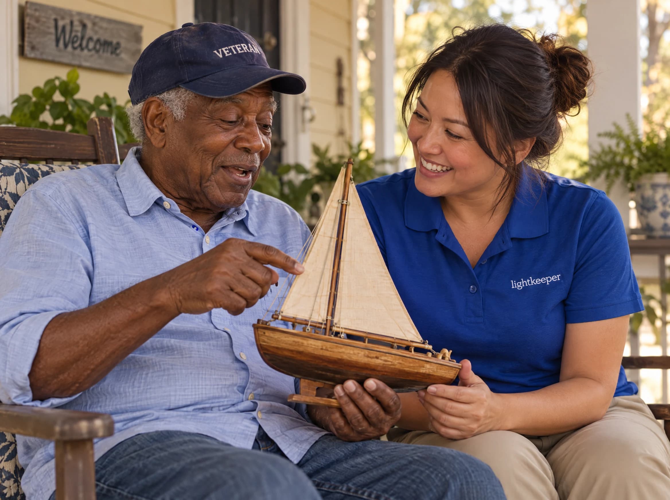 An older veteran shares the story of his handmade sailboat with his Lightkeeper on the porch