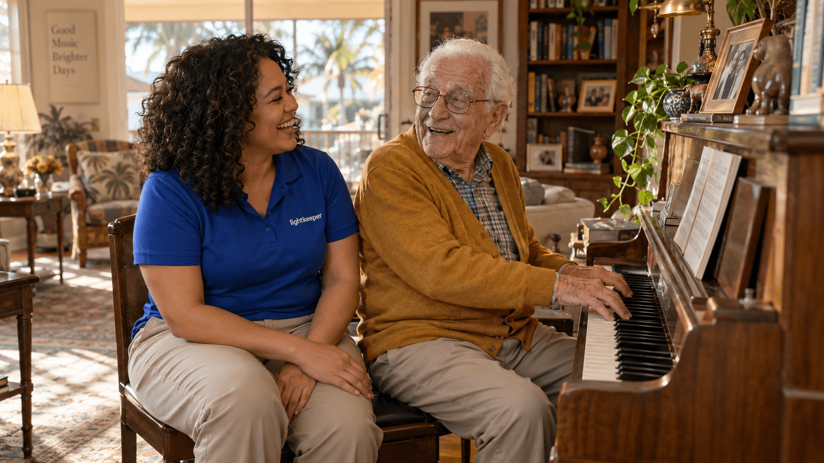 An older man at his piano laughing with a Lightkeeper beside him in his sunlit home